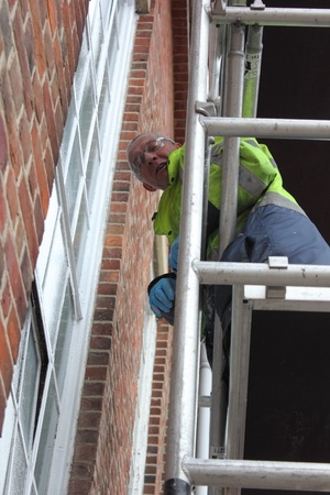 a painter and decorator working from a scaffold tower